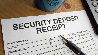 pen on paper that titled security deposit receipt